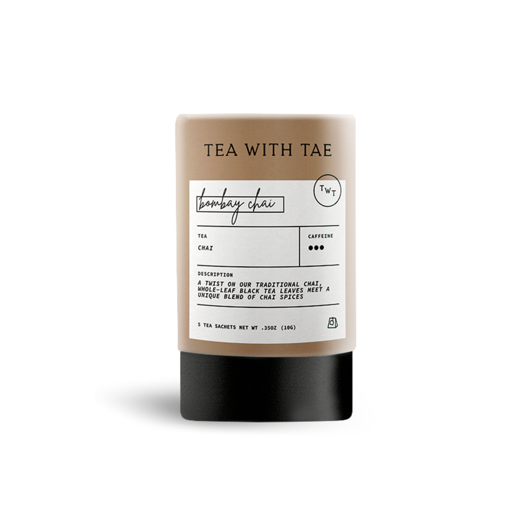 Beige cylindrical tea packaging labeled 'TEA WITH TAE' and 'bombay chai', with text describing 'Chai' tea as 'a twist on our traditional chai, whole-leaf black tea leaves meet a unique blend of chai spices', on a white background.
