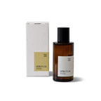 Brown glass bottle of Spiritual Room Spray standing next to its white cardboard box packaging. The bottle and box both feature labels with the text 'Spiritual Room Spray' and 'Citrusy Sweet Woody'. The bottle has a black spray nozzle and cap.