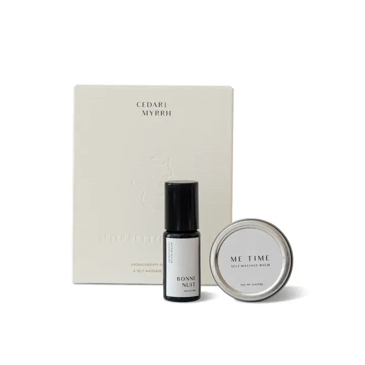 Sleep Better Ritual Kit with a cream-colored box labeled 'CEDAR MYRRH' and 'AROMATHERAPY & SELF-MASSAGE', a small black bottle labeled 'BONNE NUIT', and a silver tin labeled 'ME TIME' on a white background.