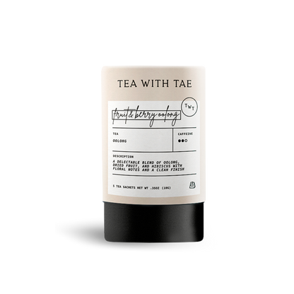 Light beige cylindrical tea packaging labeled 'TEA WITH TAE' and 'fruit & berry oolong', with text describing 'Oolong' tea as 'a delectable blend of oolongs, berries, fruit, and hibiscus with floral notes and a clean finish', on a white background.
